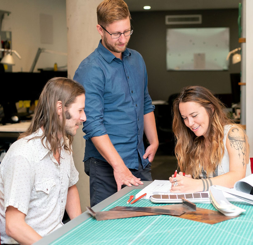 three team members working together